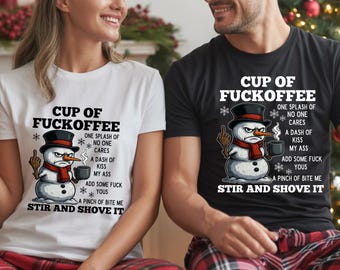 May include: Two t-shirts, one white and one black, featuring a snowman graphic. The snowman is wearing a hat and scarf, holding a coffee mug, and giving the middle finger. Text on the shirts reads "CUP OF FUCKOFFEE".