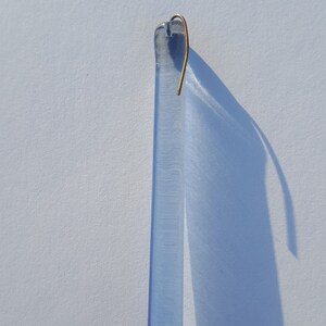 May include: A set of three ceramic mugs with a speckled, matte finish in cream, light grey, and dark grey. Each mug has a simple, modern design and a rounded handle.