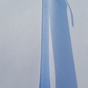 May include: A handmade wooden sign with the word "Welcome" in a whimsical font. The sign is painted white with a distressed finish, and features a small, decorative heart. It measures approximately 30 cm wide and 15 cm tall.