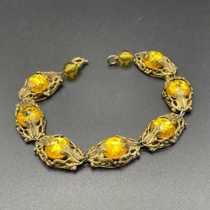 Vintage Czech filigree panel bracelet with bright yellow / orange Vauxhall glass type faceted rhinestone antique gold tone