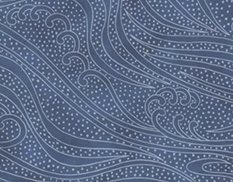 May include: Navy blue fabric with a white wave pattern. The design features stylized waves and small white dots, creating a textured and flowing appearance. The pattern is suitable for various applications.