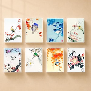 May include: A set of eight rectangular art prints featuring various birds perched on flowering branches. Each print displays detailed illustrations of birds in natural settings with vibrant colors including red, blue, green, and yellow against white or cream backgrounds.