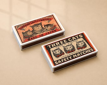 May include: Two rectangular matchboxes with brown sides. One box features an orange label with three cats and the text Superior Safety Matches Made in Japan. The other box has a black label with three cats and the text Three Cats Made in Sweden Impregnated Safety Matches.