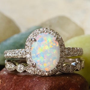 Opal engagement ring set ,2piece set, 1 milgrain CZ band and oval opal set in a halo of CZ approximately  1.5  carats