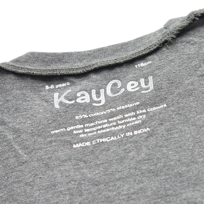 May include: Gray cotton t-shirt with a white label that says "KayCey" and includes care instructions. The label also says "95% cotton/5% elastane", "warm gentle machine wash with like colours", "low temperature tumble dry", "do not bleach/dry clean", and "MADE ETHICALLY IN INDIA".