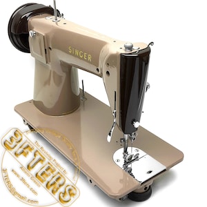 May include: A vintage Singer sewing machine in tan and brown. The machine features the Singer logo in gold lettering. The machine has a flat base and a vertical arm. The image includes the text "SINGER" and a logo for "3FTERS".