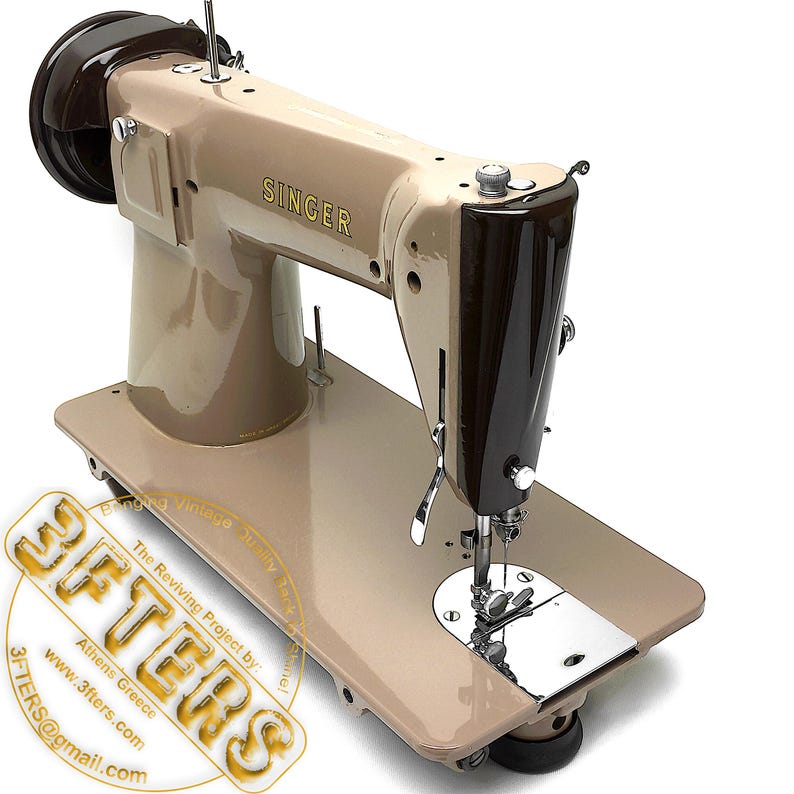 May include: A vintage Singer sewing machine in tan and brown. The machine features the Singer logo in gold lettering. The machine has a flat base and a vertical arm. The image includes the text "SINGER" and a logo for "3FTERS".