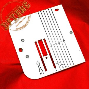 May include: A white metal sewing machine plate with black markings and the numbers 3, 4, 5, 6, 7, and 8. The plate has a red section and an arrow. The text "3FTERS" and contact information are visible.