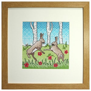 May include: Cross-stitch embroidery of two brown rabbits hopping in a green field with red flowers and a blue and white birch tree background.