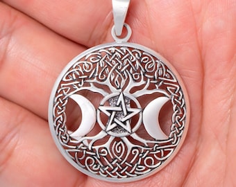 May include: Silver pendant featuring a Celtic knotwork tree of life design with three crescent moons and a pentagram star in the centre.