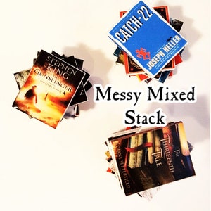 May include: A messy stack of paperback books with different titles and authors. The top book is blue with the title "Catch-22" and the author "Joseph Heller". The bottom book is brown with the title "The Thirteenth Tale" and the author "Diane Setterfield".