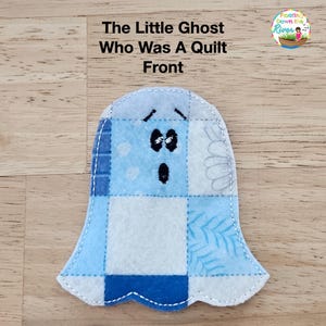 May include: A light blue ghost-shaped quilt front with a patchwork design. The ghost has black eyes and a surprised expression. The text "The Little Ghost Who Was A Quilt Front" is at the top.