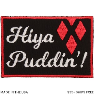 May include: Black rectangular patch with a red border. The patch features the words "Hiya Puddin'!" in white script, along with three red diamond shapes. The text "MADE IN THE USA" is at the bottom.