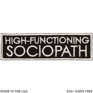 May include: Black rectangular patch with white embroidered text reading "HIGH-FUNCTIONING SOCIOPATH." The patch has a white border and is made in the USA. The patch is a humorous accessory.
