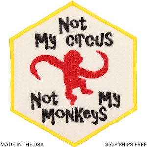 May include: Embroidered patch with a white background and a yellow border. The patch features the text "Not My Circus, Not My Monkeys" in black, with a red monkey illustration in the center. Made in the USA.