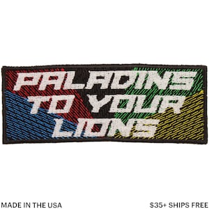 May include: Embroidered patch with the text "PALADINS TO YOUR LIONS" in white, set against a black background. The patch features a colourful design with red, blue, green, and yellow sections. The text is in a bold, stylised font.