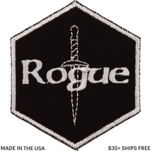 May include: Black embroidered patch with a white border and the word "Rogue" above a dagger. The patch is in a hexagonal shape. The text "MADE IN THE USA" is at the bottom.