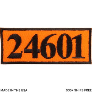 Puede incluir: Parche bordado rectangular con el número "24601" en negro sobre un fondo naranja. El parche tiene un borde negro. El texto "MADE IN THE USA" está en la parte inferior.