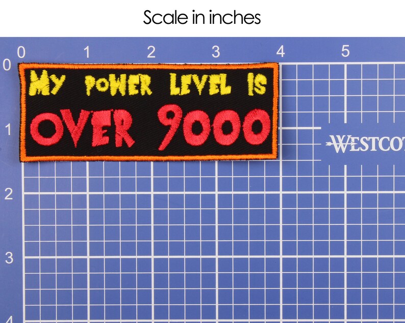 May include: A black rectangular patch with the text "MY POWER LEVEL IS OVER 9000" in yellow and red, with an orange border. The patch is approximately 4 inches long and 1.5 inches tall.