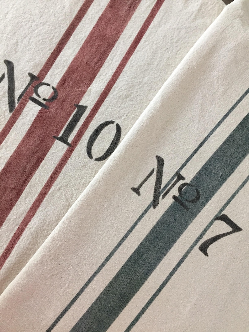 May include: Two white tea towels with red and blue stripes. The top towel has the text "No. 10" and the bottom towel has the text "No. 7".