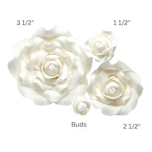 May include: An assortment of white rose blossoms and buds. The largest flower measures 3 1/2 inches, with others at 2 1/2 inches and 1 1/2 inches. The buds are also included. These flowers are ideal for crafting and decorative projects.
