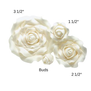 May include: Ivory-colored rose blossoms and buds in various sizes. The largest flower measures 3 1/2 inches, with others at 2 1/2 and 1 1/2 inches. The smallest is labeled "Buds". These decorative flowers are ideal for crafts.