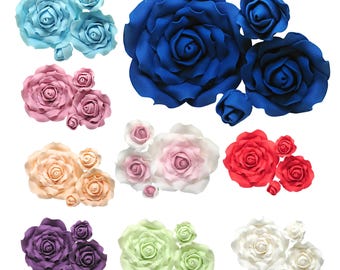 May include: A collection of artificial rose clusters in various colors including light blue, dark blue, pink, peach, white, red, purple, and light green. Each cluster features multiple roses of different sizes with layered petals.