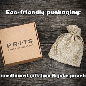 May include: Eco-friendly packaging for a product called "PR.I.TS touch relaxation". The packaging includes a cardboard gift box and a jute pouch.