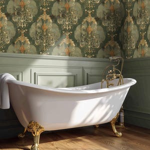 May include: A white clawfoot bathtub with ornate gold-toned feet and a matching gold-toned faucet fixture. A white towel is draped over the side of the tub. The tub features a smooth, curved basin design and stands on four decorative legs.