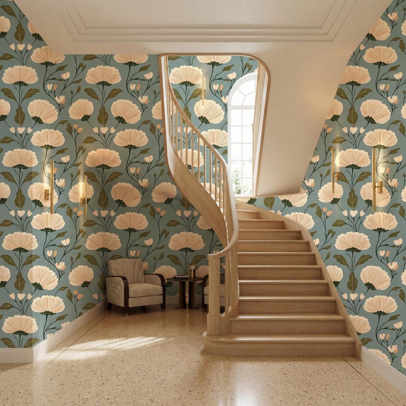 May include: An interior shot of a hallway with a wooden staircase and floral wallpaper. The wallpaper is a teal color with large, cream-colored flower patterns. A beige armchair sits near the staircase. The floor is a speckled beige.