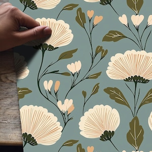 May include: Floral pattern featuring large, cream-colored flowers with brown details and green leaves on a muted teal background. The design includes smaller peach-colored buds and delicate stems, creating a cohesive and elegant botanical theme.