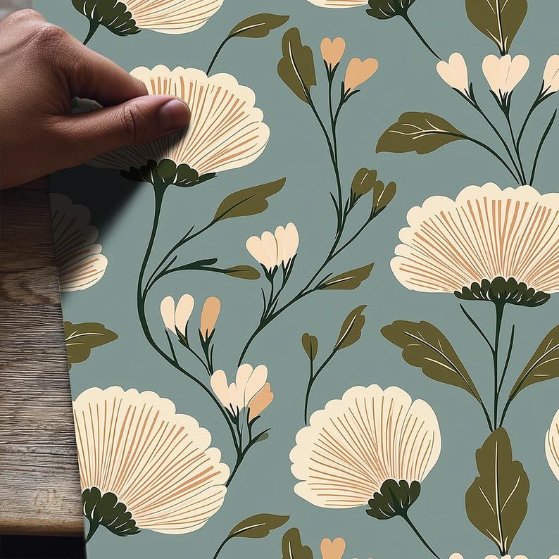 May include: Floral pattern featuring large, cream-colored flowers with brown details and green leaves on a muted teal background. The design includes smaller peach-colored buds and delicate stems, creating a cohesive and elegant botanical theme.