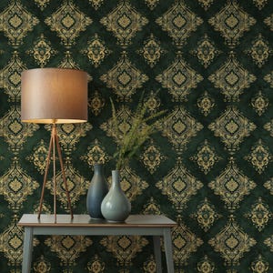 May include: A dark green and gold damask wallpaper pattern. A floor lamp with a brown lampshade and copper legs is on the left. Two vases and greenery are on a gray table in front of the wallpaper.