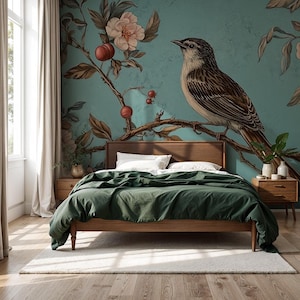 May include: A bedroom featuring a wooden bed frame, a dark green duvet cover, and white pillows. The wall is adorned with a large mural of a bird on a branch with flowers and fruit. The room has a neutral rug and curtains.