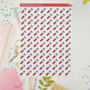May include: A sheet of stickers with a white background and a red, white, and blue test tube design. The sheet is labeled "Organizing Chaos".