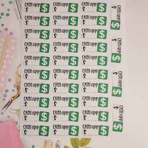 May include: A sheet of green and white stickers with the text "CASH app" and a dollar sign on each sticker. The stickers are arranged in rows and columns on a white background. The text "ORGANIZING CHAOS" is at the top of the sheet.
