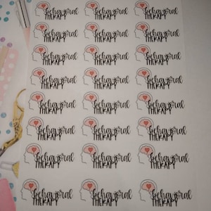 May include: A sheet of stickers with a brain outline and a heart inside, with the text "behavioral therapy" on each sticker. There are 18 stickers in total.