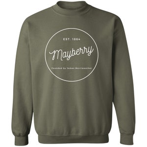 May include: A green sweatshirt with a white circle logo that says "Mayberry" with the text "EST. 1864" and "Founded by James Merriweather" underneath.