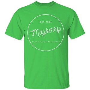 May include: A green t-shirt with a white circle graphic that says "Mayberry" with the text "EST. 1864" and "Founded by James Merriweather" underneath.