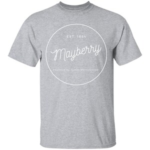 May include: A gray t-shirt with a white circle graphic that says "Mayberry" with the text "EST. 1864" and "Founded by James Merriweather" underneath.