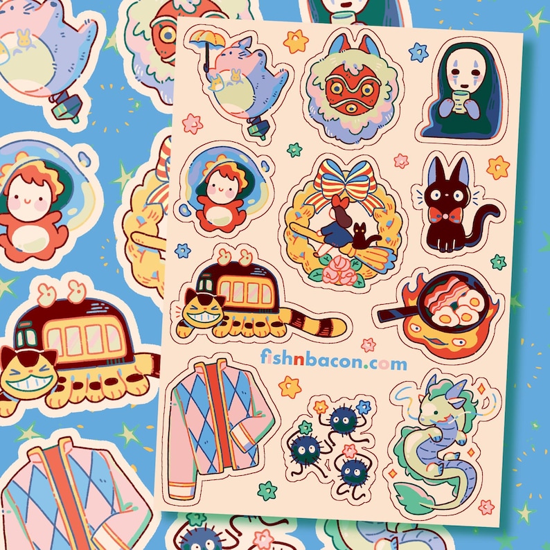 May include: A sheet of colourful stickers featuring various cartoon characters and designs. The stickers include a train with a smiling face, a dragon, a cat with a bow tie, and a character with a mask. The website fishnbacon.com is printed on the sheet.