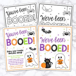 May include: Two printable Halloween "You've Been Booed!" signs with instructions on how to play the game. The signs feature ghosts, bats, spiders, and a black cat.
