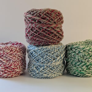 May include: A white ceramic mug with a black handle and the text "But First, Coffee" in a bold, black font. The mug is set against a neutral background, highlighting its simple design.