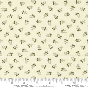 May include: A white fabric with a repeating pattern of small green sprigs. The fabric has a subtle texture and a slightly off-white background.