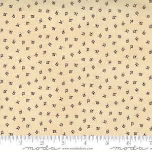 May include: A beige fabric with a repeating pattern of small brown flowers. The fabric is measured in inches.