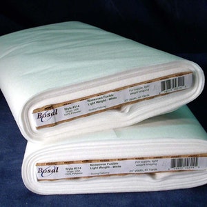 May include: Two rolls of white nonwoven fusible fabric, labeled "Bosal Style #314 Nonwoven Fusible Light Weight - White Sewing/Tailoring 20" Width, 40 Yards"