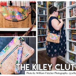 May include: A cork and faux leather clutch bag with a colorful splatter paint design. The bag has a zipper closure and a long strap. The bag is shown in two different sizes. The text "The Kiley Clutch" is displayed at the bottom of the image. The text "Photo by William Fletcher Photography - @wfletcherphoto" is displayed below the bag.