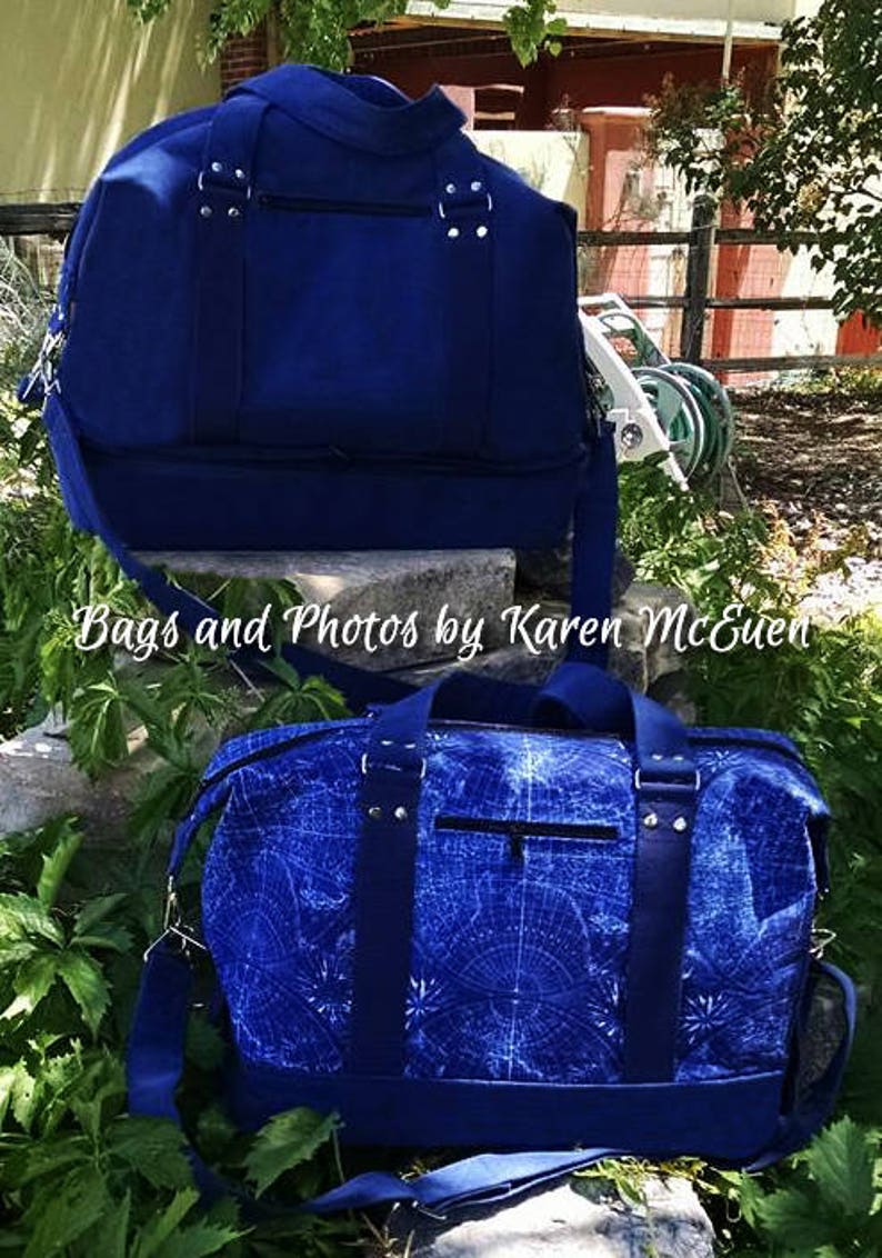 May include: Two blue canvas duffel bags. The top bag is solid blue. The bottom bag has a white and blue geometric pattern. Both bags have a zippered pocket on the front and a top handle.