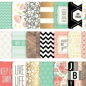 May include: A collection of decorative cards with various designs and inspirational quotes. The cards feature floral patterns, geometric shapes, and phrases like "Be True" and "Live Life". Colors include white, black, gold, and pastel shades.