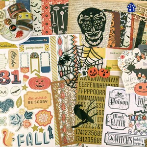 May include: A collection of Halloween-themed scrapbook supplies. Includes decorative paper, stickers, washi tape, and wooden cutouts. Features pumpkins, spiders, skulls, and the text "Trick or Treat". Colors include orange, black, and cream.